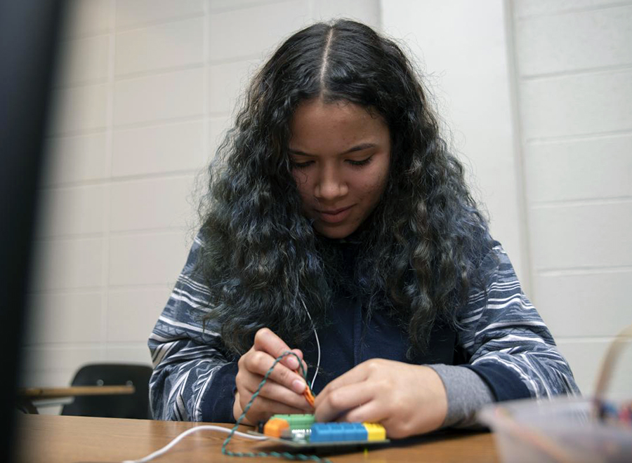 girl works on hummingbird kit