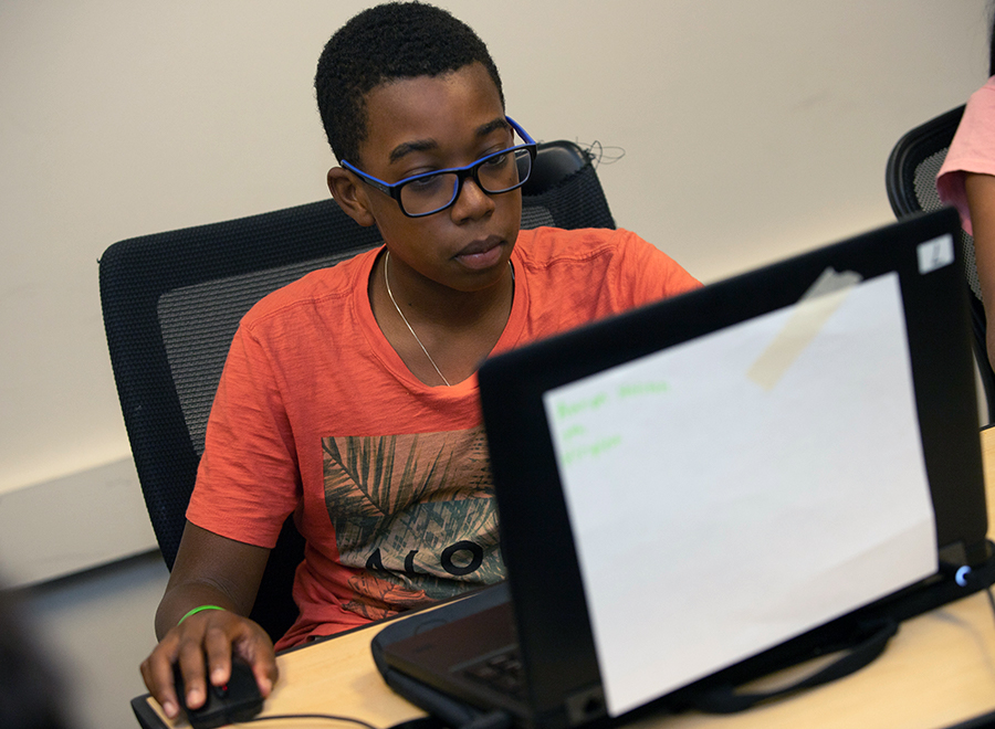 Boy plays on computer