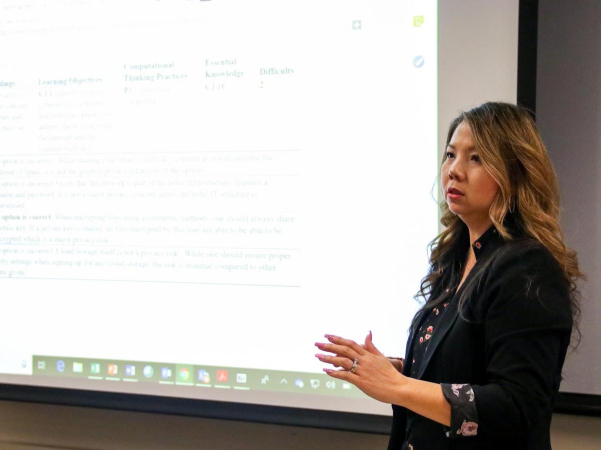 Lien Diaz presents activities to attendees.