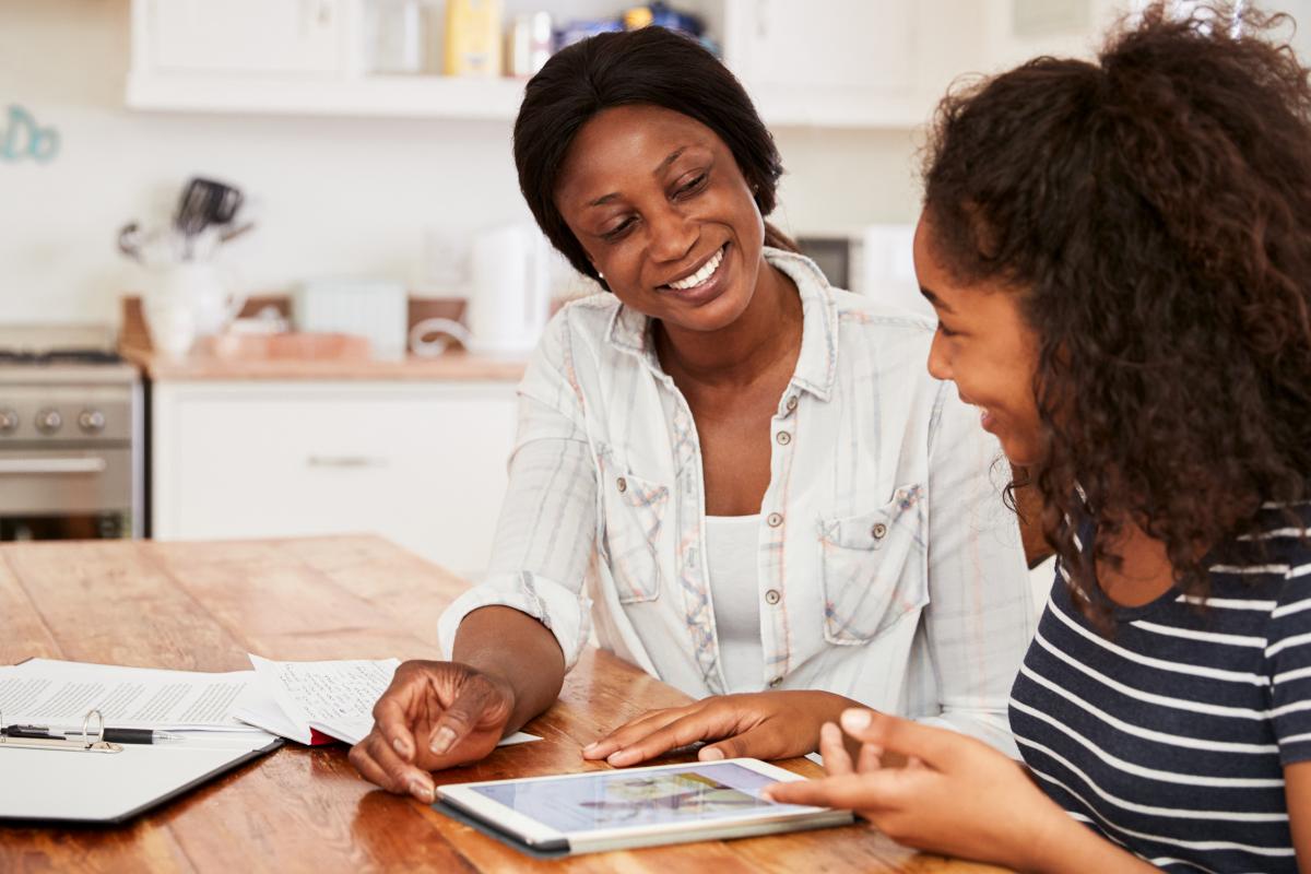 Mom helps daughter with homework.