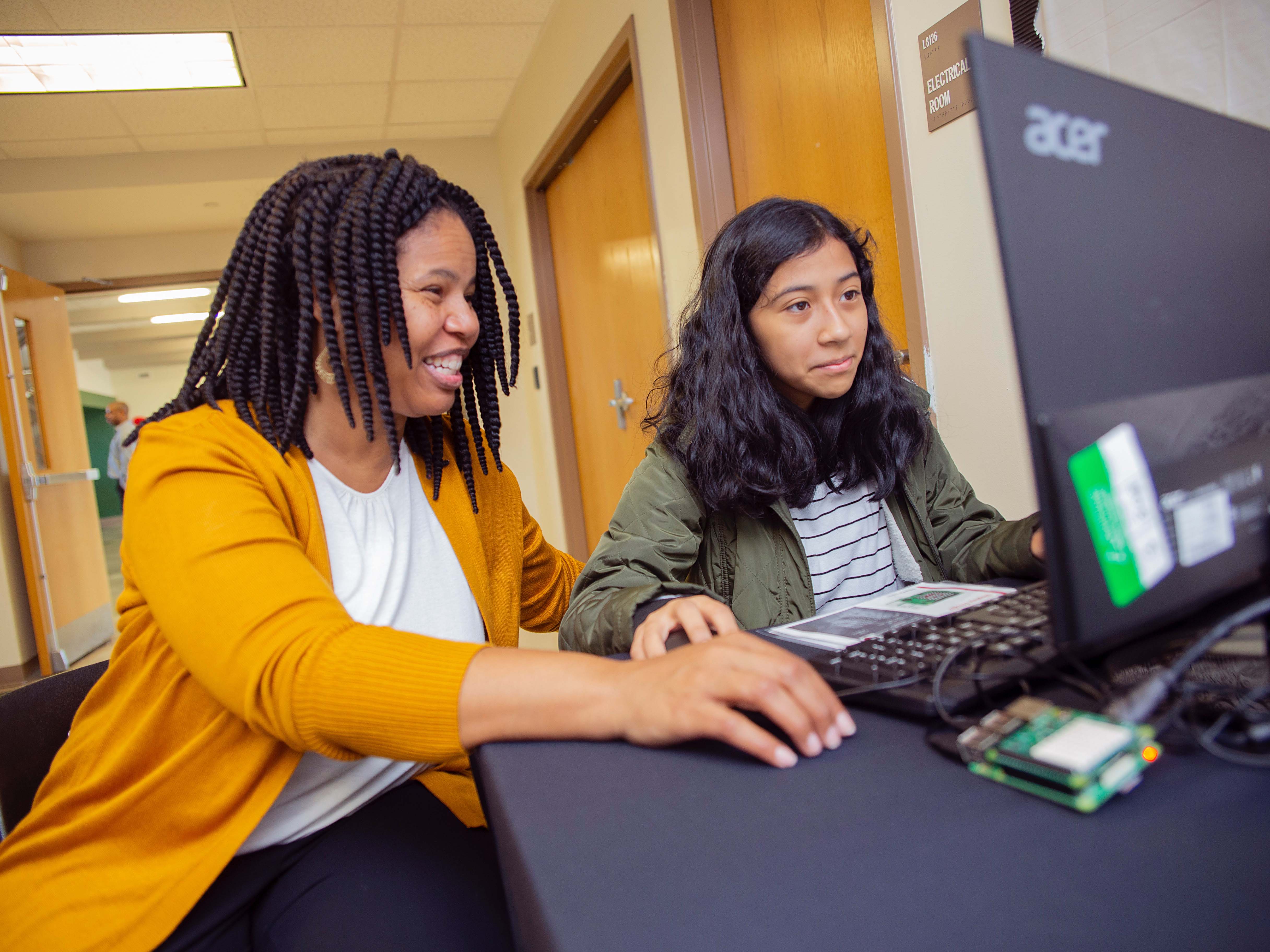 Yolanda Payne helps a student create their own emoji with Raspberry Pi.