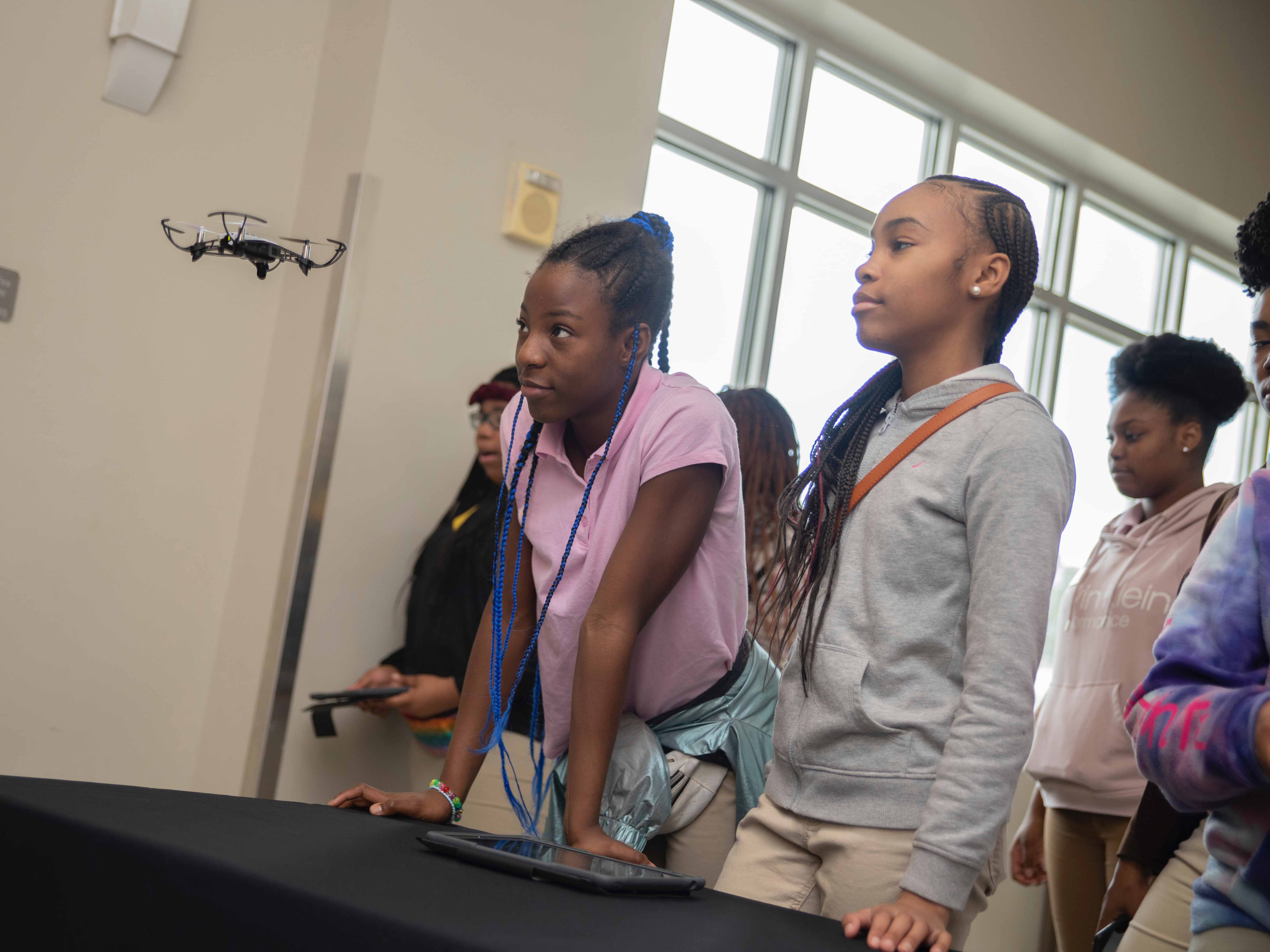 girls fly drone during computer science education week