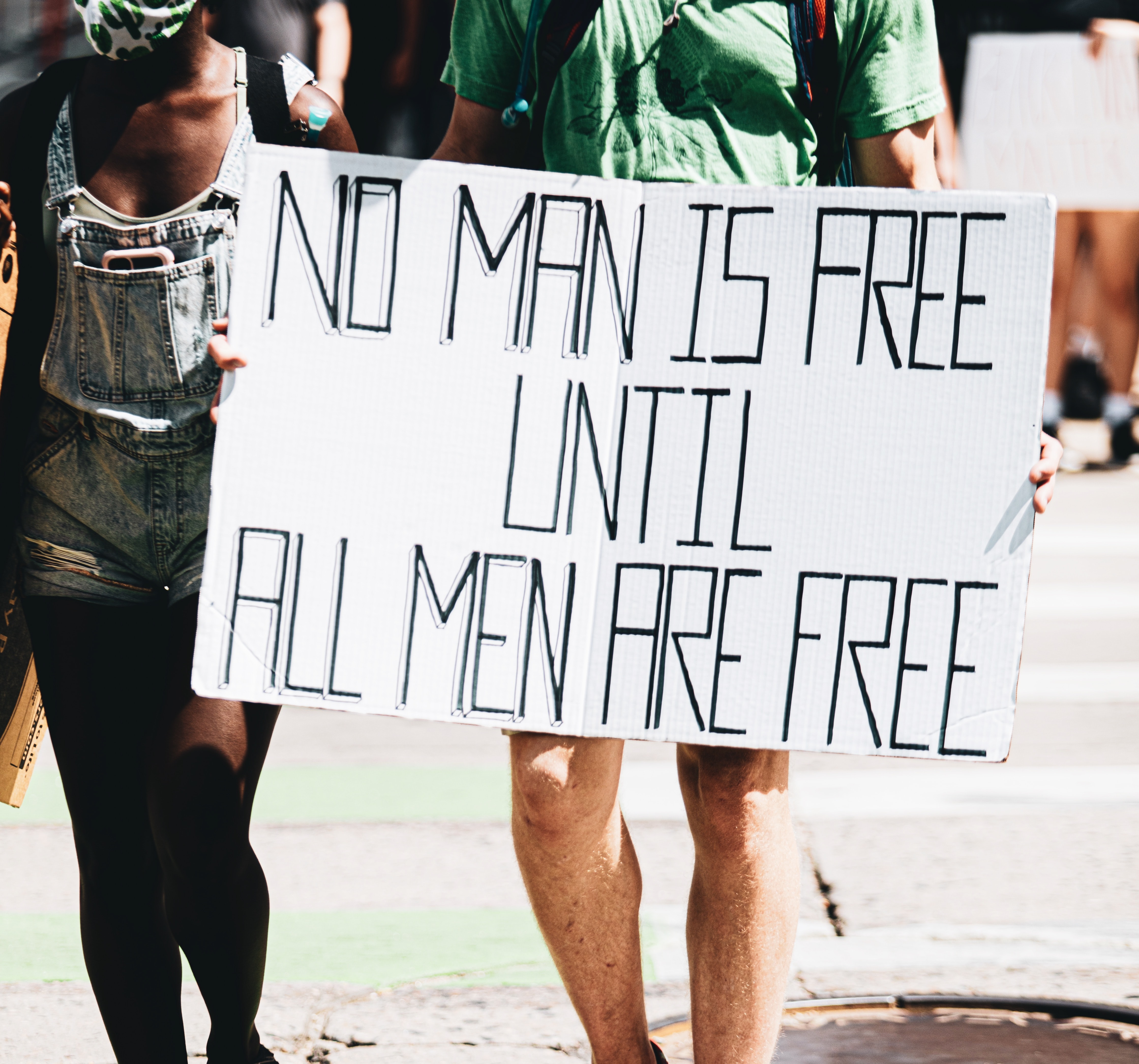 No man is free until all men are free sign